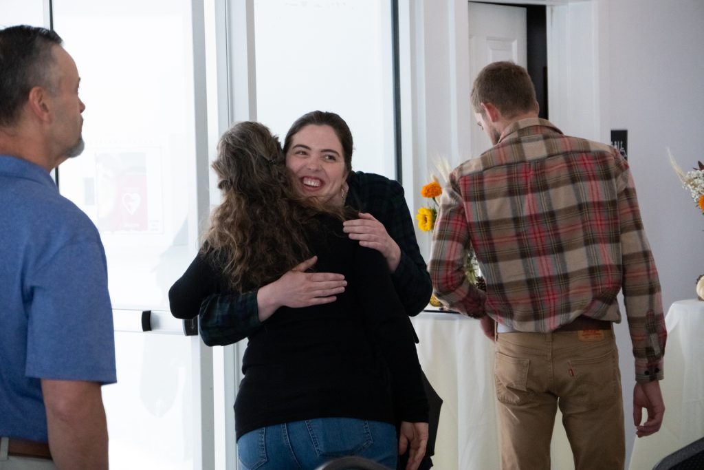 Attendees embracing each other