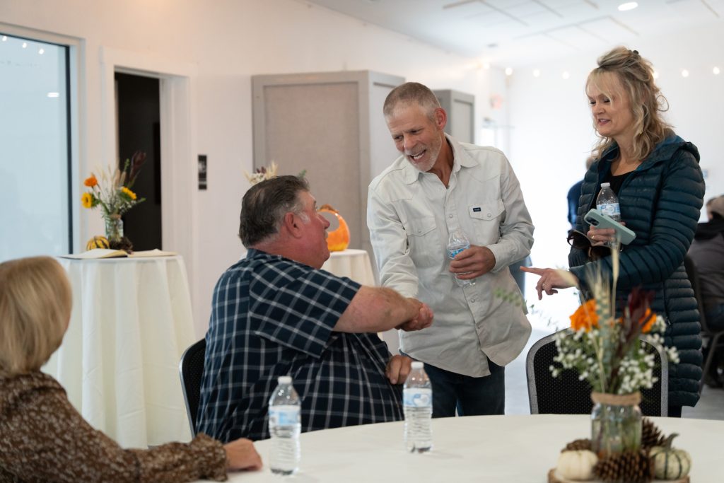 Attendees greeting each other