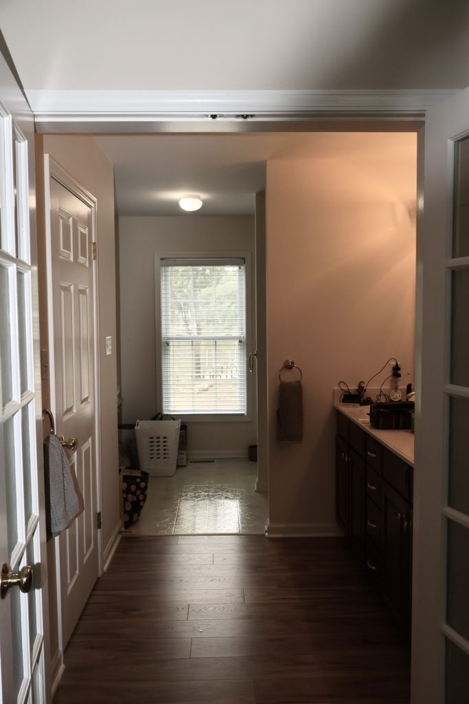 Before Bathroom Remodeler with entrance to dated bath