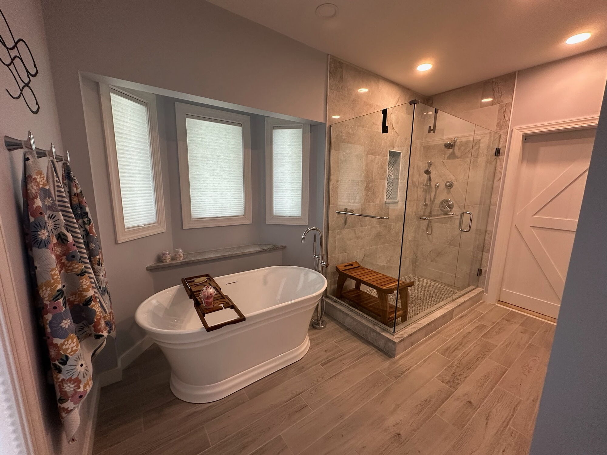 Custom bathroom remodeling featuring a walk-in shower and Signature Hardware Odenwald 59-inch acrylic soaking tub.